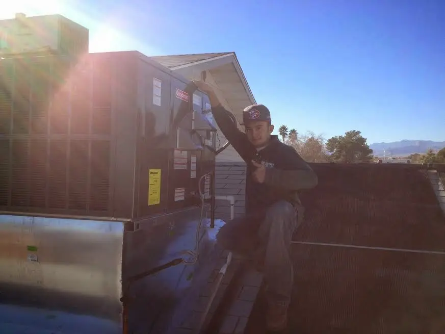 HVAC technician performing HVAC Inspection on a rooftop unit in Oakdale